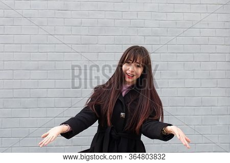 The Beautiful Brunette On The Street In Bewilderment