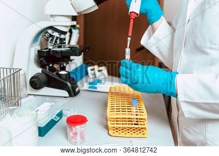 Close-up Photo Of Lab Technician Working With Micropipette And Samples. Blood Plasma As Coronavirus 