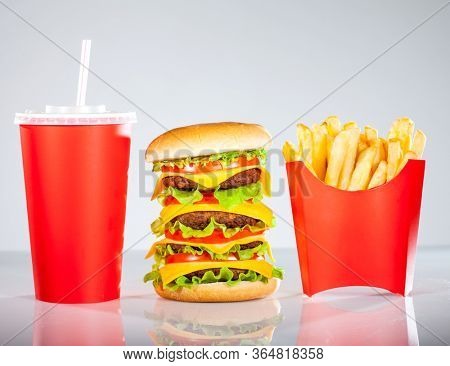 Tasty hamburger and french fries on a white background