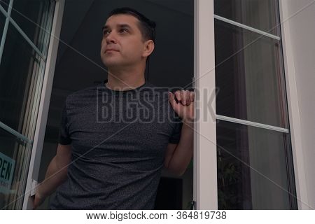 Quarantine Covid-19 Is Over Concept. Business Owner Opens The Door And Looks Out Onto The Street. Th
