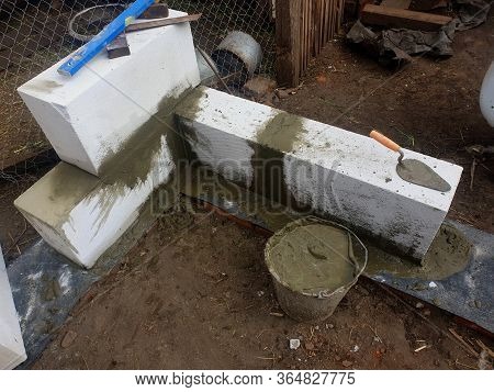Bricklayer Builder Laying Autoclaved Aerated Concrete Blocks, Aac On House Foundation Wall.
