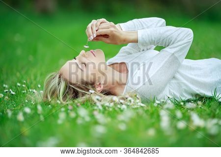 Beautiful Woman With A Flower. Girl With Camomiles. Beautiful Woman Portrait.