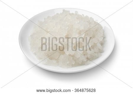 Bowl with organic probiotic water kefir grains isolated on white background 