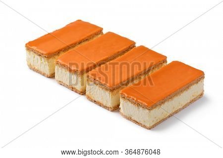 Row of traditional Dutch orange Tompouce pastry for kings day isolated on white background