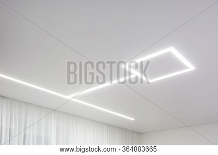 Looking Up On Suspended Ceiling With Halogen Spots Lamps And Drywall Construction In Empty Room In A