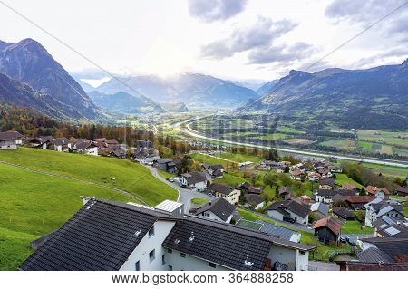 Scenic Aerial View Of Hillside Villages In Triesenberg And The River Rhine, Natural Border Of Liecht