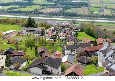 Scenic Aerial View Of Hillside Villages In Triesenberg And The River Rhine, Natural Border Of Liecht