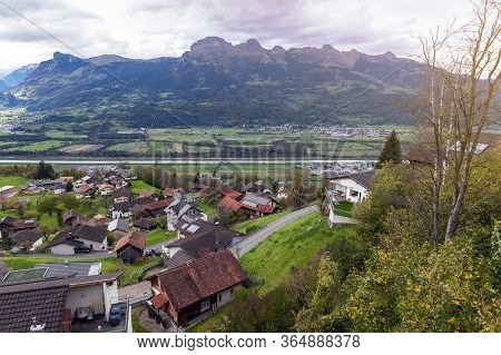 Scenic Aerial View Of Hillside Villages In Triesenberg And The River Rhine, Natural Border Of Liecht