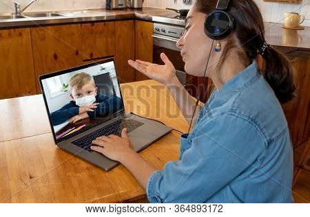 Covid-19 Online Education. Primary Teacher And Pupil Interacting In Live Video Lesson. Woman Tutor W