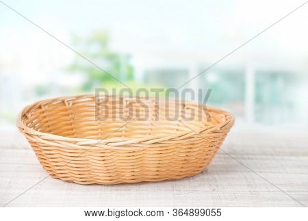 Wicker Basket On A White Wooden Table