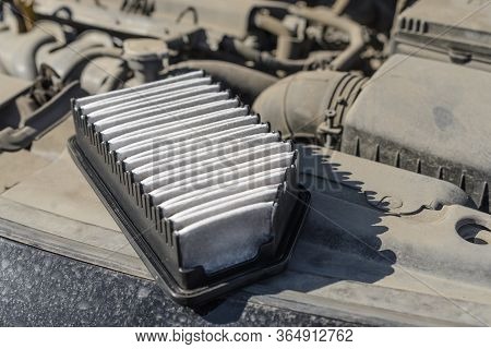 A Dirty Car Engine Air Filter Is In The Engine Compartment.