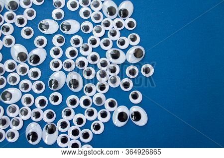 Googly Toy Eyes On Classic Blue Background. Concept Of Personal Data Security, Surveillance, Espiona