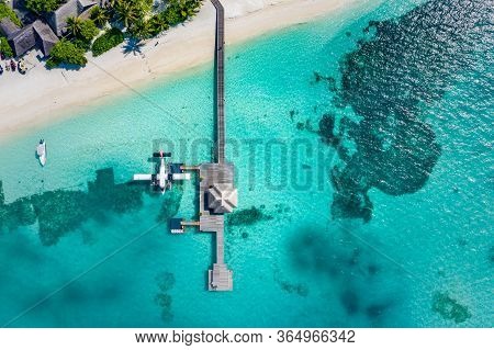 Perfect Aerial Landscape, Luxury Tropical Resort Or Hotel With Water Villas And Seaplane And Wooden 