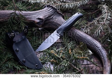 Knife With A Fixed Blade On A Plastic Sheath. Deer Horn And Knife.