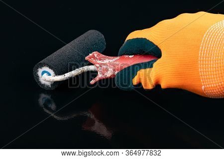 Paint Roller In Hand. Painting Oil Paint On Flat Surfaces.