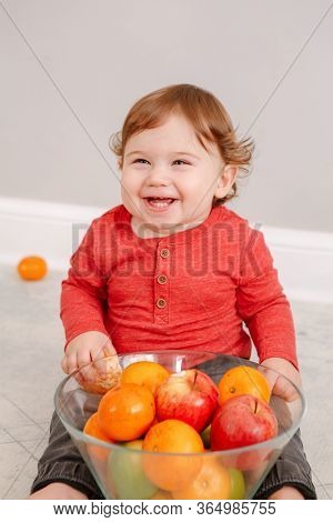 Cute Adorable Caucasian Baby Boy Eating Citrus Fruit. Finny Child Eating Healthy Organic Snack. Soli