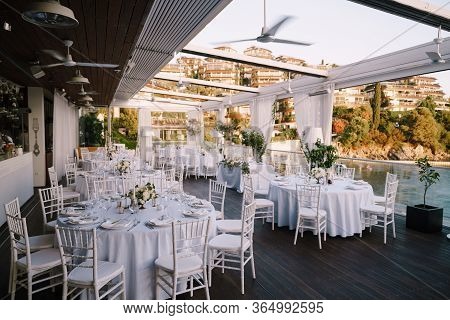 Wedding Dinner Table Reception. Lots Of Round Tables With White Tablecloths And White Chiavari Chair
