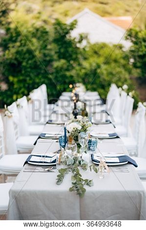 Wedding Dinner Table Reception. Table Serving The Table With Grey Tablecloth With White Plates, With