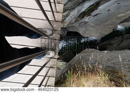 Zillis, Grison, Switzerland, April 12, 2022 Standing On A Small Pedestrian Bridge And Looking Down T