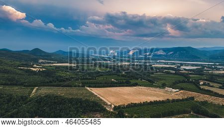 View Of The Surrounding Farmland. With A Cloudy Sky. Storm Clouds Over The Village Of Cruas - France