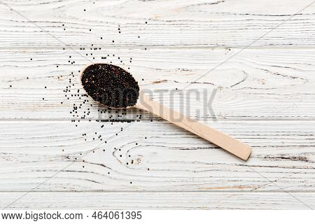 Quinoa Seeds In Spoon On Colored Background. Healthy Kinwa In Small Spoon. Healthy Superfood.