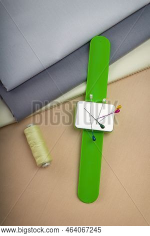 Wrist Tailor's Bracelet Is A Magnet For Pins And Metal Fittings, Along With A Spool Of Thread, Lies 