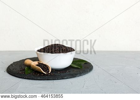 Quinoa Seeds In Bowl And Spoon On Colored Background. Healthy Kinwa In Small Bowl. Healthy Superfood