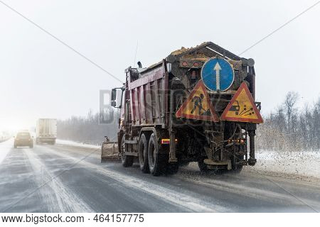 Snowplow Truck Removing Dirty Snow From City Street Or Highway After Heavy Snowfalls. Traffic Road S