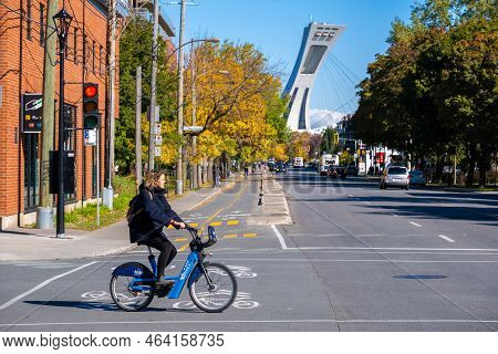 Montreal, Ca - 10 October 2022: Woman Riding A Bixi Bike On Rachel Street In Autumn