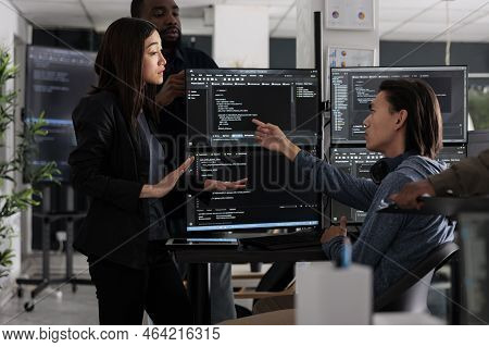 Diverse Team Of Programmers Coding Html Script Information On Computer At Desk Table, Parsing Source