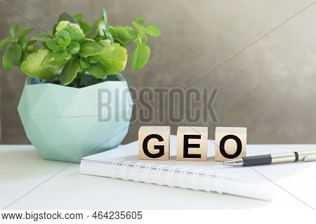 Geo. Text On Wood Cubes. Text In Black Letters On Wood Blocks
