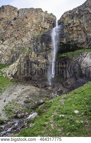 Alpine Waterfall In The Mountains Of Kyrgyzstan Flowing From Melting Glaciers Close-up
