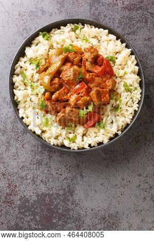 Porkolt Is A Classic Hungarian Cuisine Beef Stew With Onions And Plenty Of Paprika Close-up In A Pla