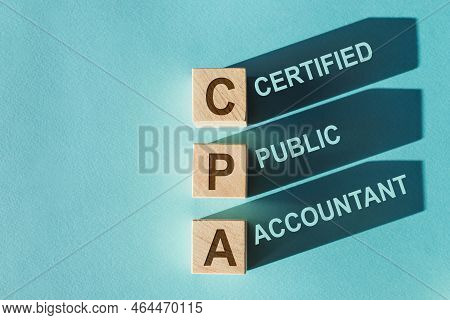Wooden Cubes Building Word Cpa - Abbreviation Of Certified Public Accountant - With Shadows On Light