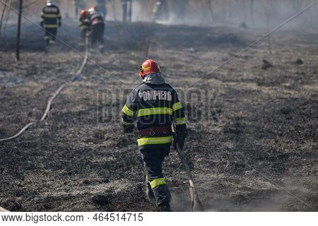 Bucharest, Romania - April 5, 2022: Firefighters Try To Extinguish A Wildfire Of Vegetation In The V