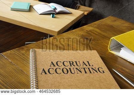 Accrual Accounting Guide Near A Folder On The Table.