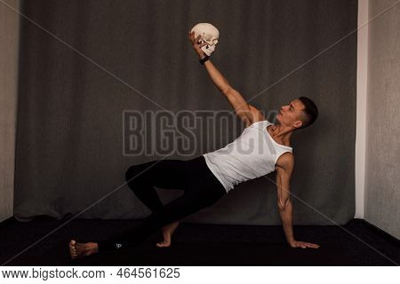 A White Skull In The Hands Of A Man. Anatomy