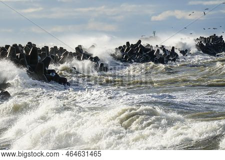 High Waves Crash Against The Harbor Breakwater Concrete Tetrapods During Stormy Weather