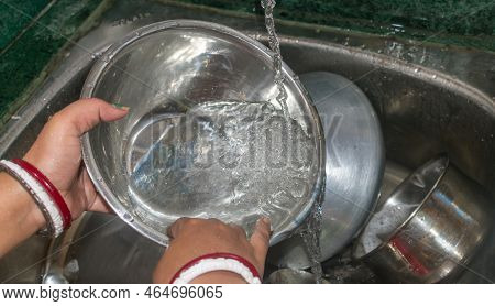 Cropped Image Of Attractive Young Indian Woman Is Washing Dishes Close Up. Daily Task Concepts. Sele