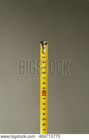 Yellow Centimeter Tape Measure On Neutral Background. Measuring Tape Concept. Measurement Concept.