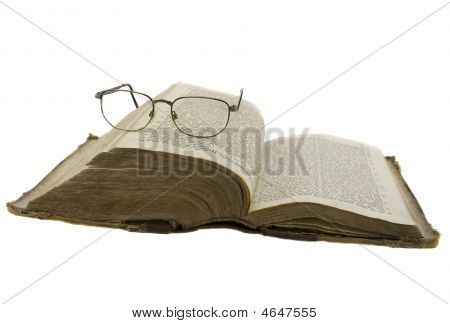 Vintage Open Book Bible Open And Glasses On It Isolated Over White