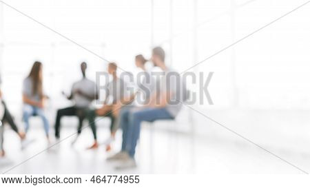 Blurry Image Background Image Of A Group Of Young People At A Meeting In A Conference Room