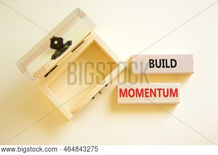 Build Momentum Symbol. Concept Words Build Momentum On Wooden Blocks. Beautiful White Table White Ba