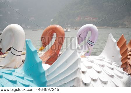 Swan Shaped Boats Tied On Lake Edge In Kashmir Bhimtal Naukuchiatal On The Blue Waters With Forests 