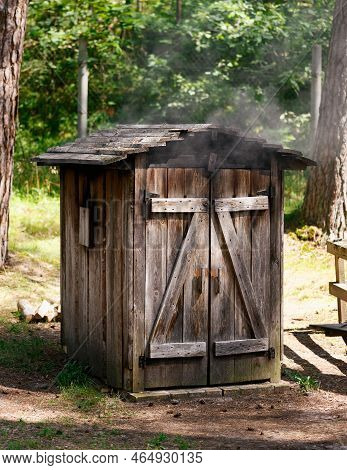 Smoking In A Wooden Smoke House, Homemade Smokery. Making Tasty Savoury Charcuterie In Smokehouse.