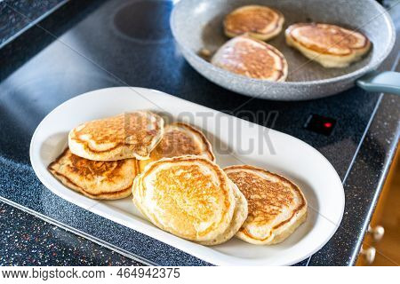 Freshly Made Pancakes On A White Serving Plate.