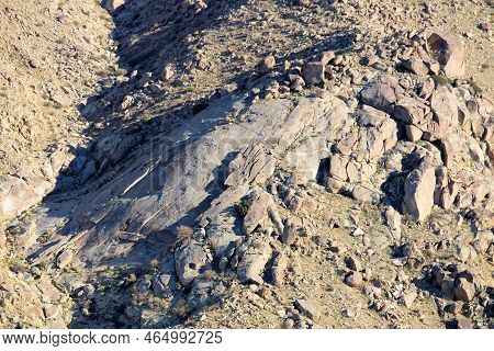 Granite Rocks On An Arid Mountain Ridge Surrounded By A Canyon With Natural Shadows During Sunset Ta