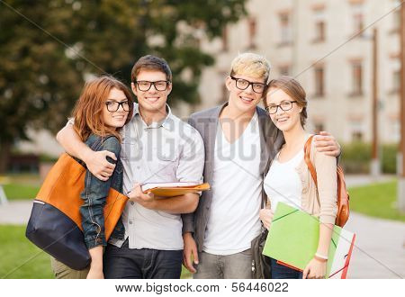 summer holidays, education, campus and teenage concept - group of students or teenagers with files, folders and eyeglasses hanging out