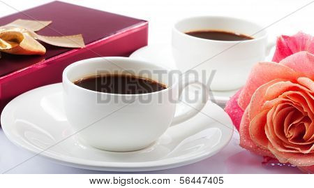 Cup of Coffee, Candy box  and Beautiful Bouquet of Fresh Flowers on Table