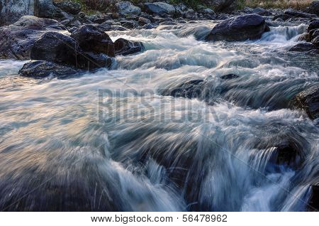 River Water Flowing Through Rocks At Dawn